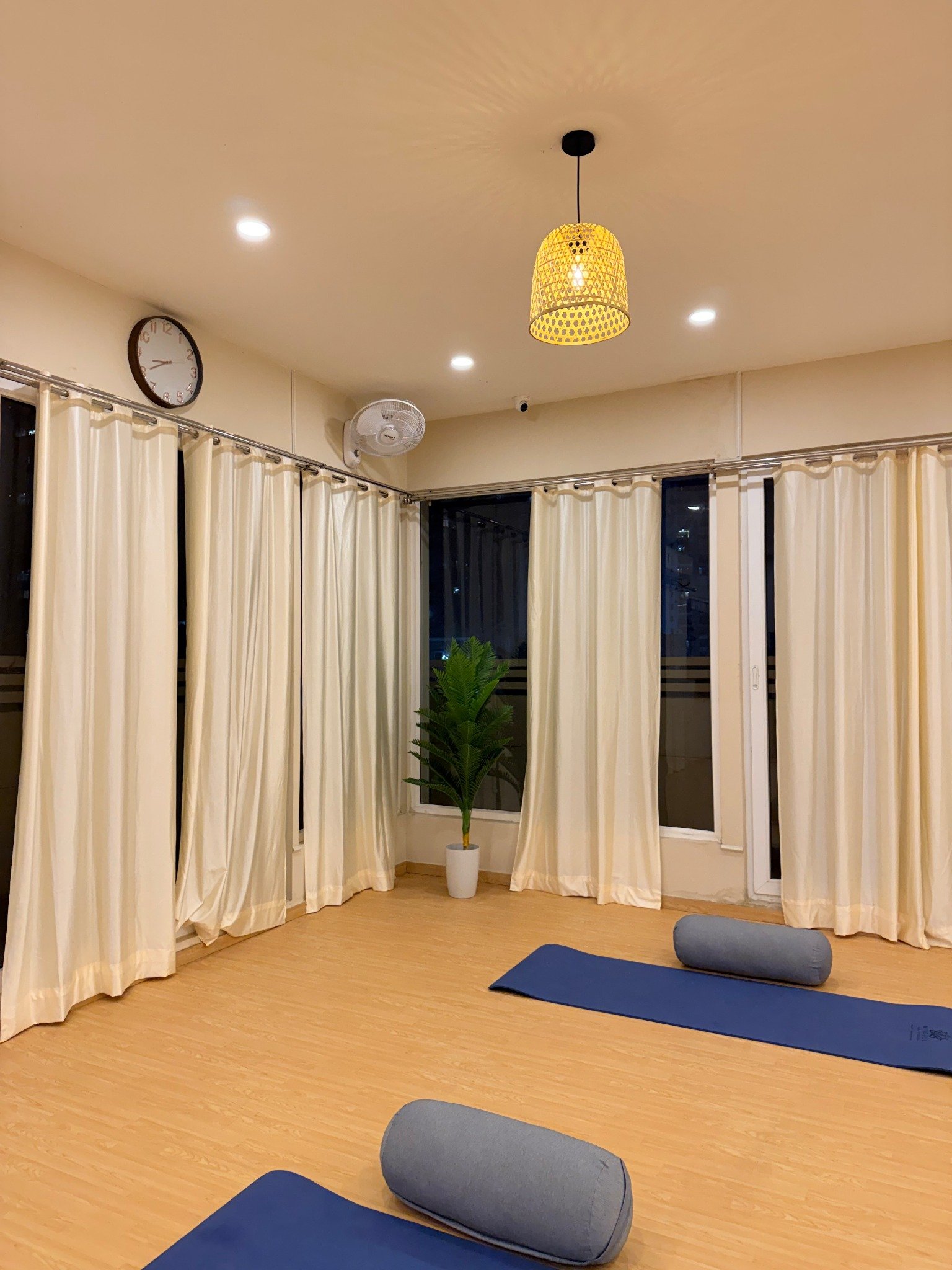Yoga practice room with curtains and mats